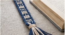Inkle woven bookmark with tassel in a book